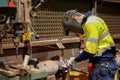 Side picture of miner worker wearing a safety glove eyes protection while using table grinding wheel