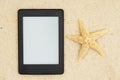 An e-reader on the beach for your summer reading Royalty Free Stock Photo