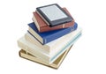 E-reader with blurred text on stack of printed books Royalty Free Stock Photo