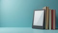 E-reader, hardcover books displayed against light blue background represent digital, traditional reading. Modern tech meets Royalty Free Stock Photo