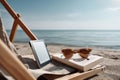 E-reader and sunglasses on sandy beach by the sea on a relaxing summer day Royalty Free Stock Photo