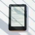 E-reader with a visible screen displaying text in Lorem Ipsum, set on a white surface.