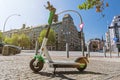 E-Scooter standing on the pavement in a big city with scenic lens flare