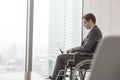 Side view of disabled businessman using laptop in boardroom at modern office