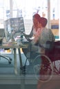 Female graphic designers working together at desk in a modern office Royalty Free Stock Photo