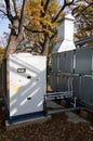 Side view of the gray industrial central conditioner with DX coil and big condensing unit standing outdoor on the ground covered b Royalty Free Stock Photo