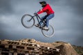 Young man jumping over hole in dirtjump circuit Royalty Free Stock Photo