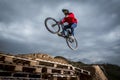 Young man jumping over hole in dirtjump circuit Royalty Free Stock Photo