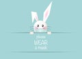 Happy Easter white bunny rabbit Wear a protective face mask against covid-19. Coronavirus alert for Easter card, banner sign Royalty Free Stock Photo