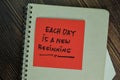 Each Day is A New Beginning write on sticky notes isolated on Wooden Table Royalty Free Stock Photo