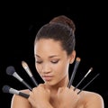 Each fulfills a different function. A young woman holding makeup brushes.