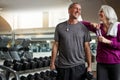 We each others motivation for fitness. a senior married couple laughing and taking a break from their workout at the gym Royalty Free Stock Photo