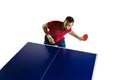 Young man playing table tennis on white studio background