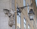 Eagle and a black street lamp whose holder incorporates two ravens on a boat, the symbol of Lisbon.