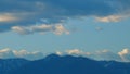 Eagle Flies In The Cloudy Blue Sky Over Snow Mountains. Bird Silhouette. Birding Adventure. Still.