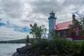 Eagle Harbor Lighthouse stands above a rocky entrance to Eagle Harbor