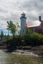 Eagle Harbor Lighthouse stands above a rocky entrance to Eagle Harbor