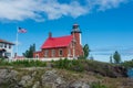 Eagle Harbor Lighthouse stands above a rocky entrance to Eagle Harbor