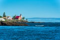 Eagle Harbor Lighthouse stands above a rocky entrance to Eagle Harbor