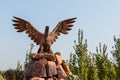 Eagle statue with spread wings on the mountain against the sky