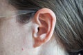 Ear and auricle, part of cheek, hair, skin and glasses. Royalty Free Stock Photo