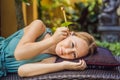 Ear candling being carried out on an attractive caucasian woman in a spa Royalty Free Stock Photo