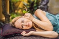 Ear candling being carried out on an attractive caucasian woman in a spa Royalty Free Stock Photo