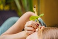 Ear candling being carried out on an attractive caucasian woman in a spa Royalty Free Stock Photo