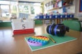 Ear Defenders Or Headphones And Fidget Toy To Help Child With ASD Or Autism On Table In School Classroom