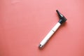 ear examining otoscope on red background