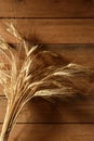 Ear golden wheat spike over wooden background