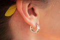 Ear of a happy woman with a beautiful earring Royalty Free Stock Photo