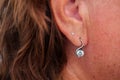 Ear of a happy woman with a beautiful earring Royalty Free Stock Photo