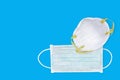 Ear-loop face mask 3 ply, Safety N95 masks on blue background. dust protection respirator and breathing medical respiratory mask