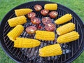 Ear of maize or corn and tomatoes on grill. Photo of vegetable on barbeque grate. Cooking process Royalty Free Stock Photo