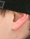 The ear of a man in a hat as a background Royalty Free Stock Photo