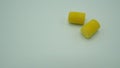 Ear plugs on white background.It is yellow color Royalty Free Stock Photo