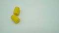 Ear plugs on white background.It is yellow color Royalty Free Stock Photo