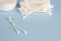 Ear sticks and cotton pads on pastel blue background. Makeup removal and skin care concept. Royalty Free Stock Photo