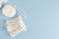 Ear sticks and cotton pads on pastel blue background. Makeup removal and skin care concept. Royalty Free Stock Photo