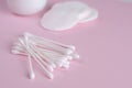 Ear sticks and cotton pads on pastel pink background. Makeup removal and skin care concept. Royalty Free Stock Photo