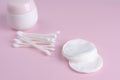 Ear sticks and cotton pads on pastel pink background. Makeup removal and skin care concept. Royalty Free Stock Photo