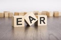 ear text on wooden blocks. wooden background. foreground