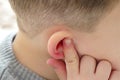 earache in children,a child holding his ear,child suffering from earache,ear inflammation