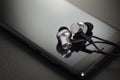 Earbuds on black smartphone Royalty Free Stock Photo