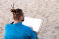 Earded man with bun on head in blue kimono sitting, holding large book Royalty Free Stock Photo