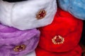 Earflaps fur caps with red stars in souvenir shop in Moscow street. Winter hats, soviet and russian military uniform