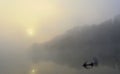Earlier morning on a calm river with a fog and a sun Royalty Free Stock Photo