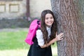 Early autumn. Happy child in uniform stand at tree. Back to school. Autumn term. Startup. Compulsory education. Dress