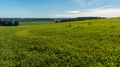 Early autumn rural landscape with meadows, forests, small hills and blue sky with clouds Royalty Free Stock Photo